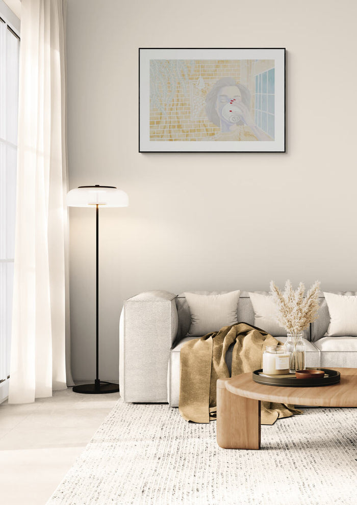 Framed "Coffee Break" by Christine Buchholtz hanging above a modern beige sofa in a cozy living room.