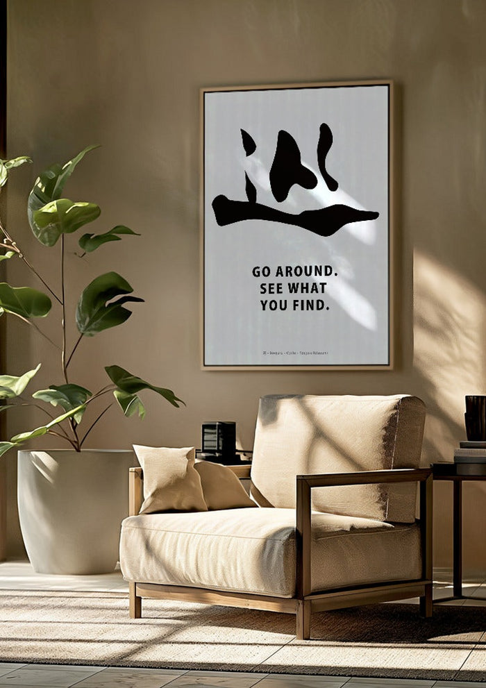 Cycle by KOUYOU KITAZUMI framed above a beige armchair beside a potted plant