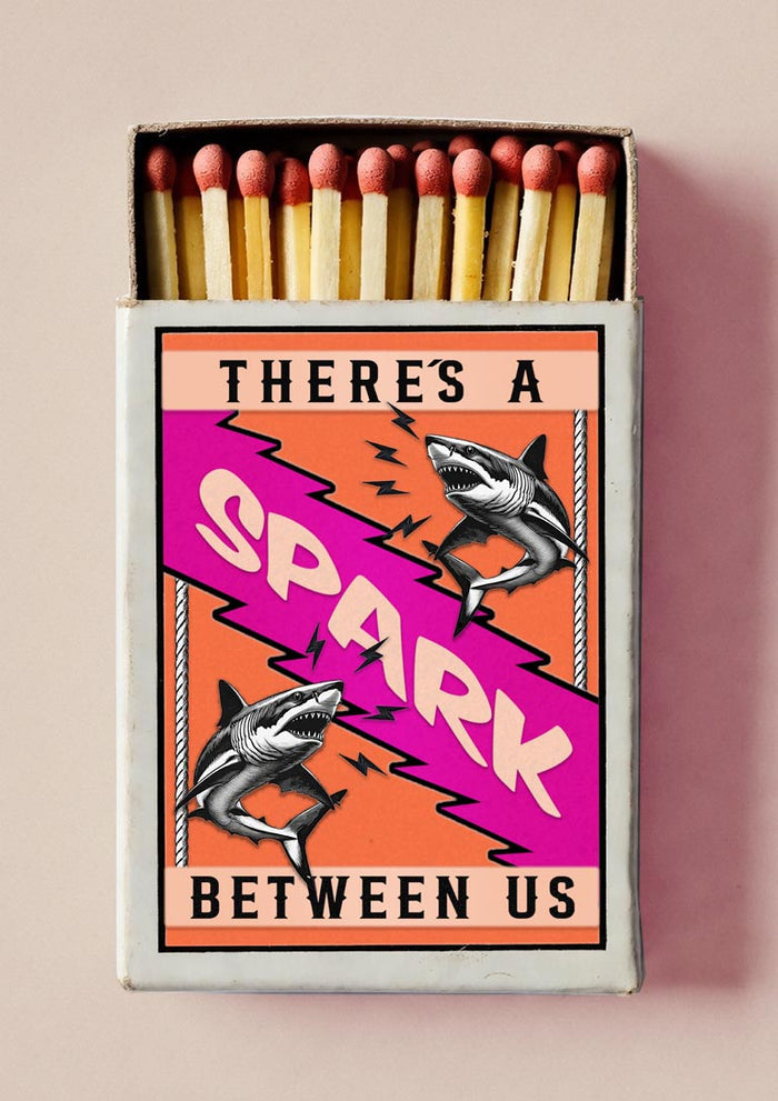 There's a Spark by Daniel Leo — vintage matchbox poster with two engraved sharks and a magenta lightning bolt