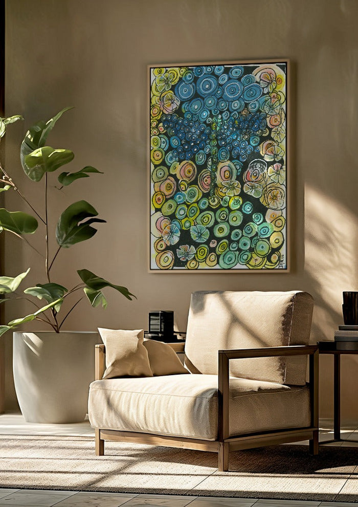 Tree of Circles by JHN.ByHjort framed above a beige armchair beside a potted plant