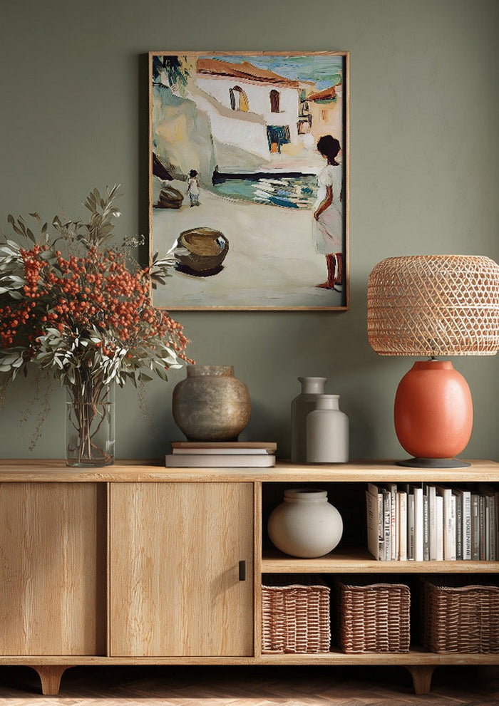 Village Street by Elena Avanesova above a wooden sideboard on a sage green wall