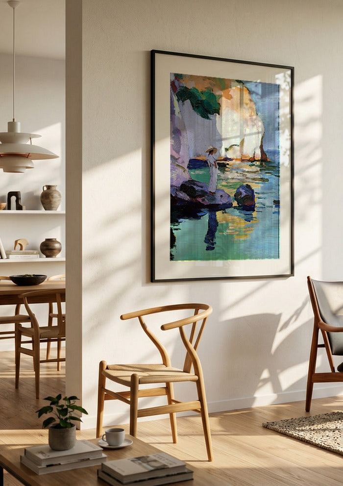 Woman by the Cliffs by Elena Avanesova in a black frame in a bright dining room with wooden chairs