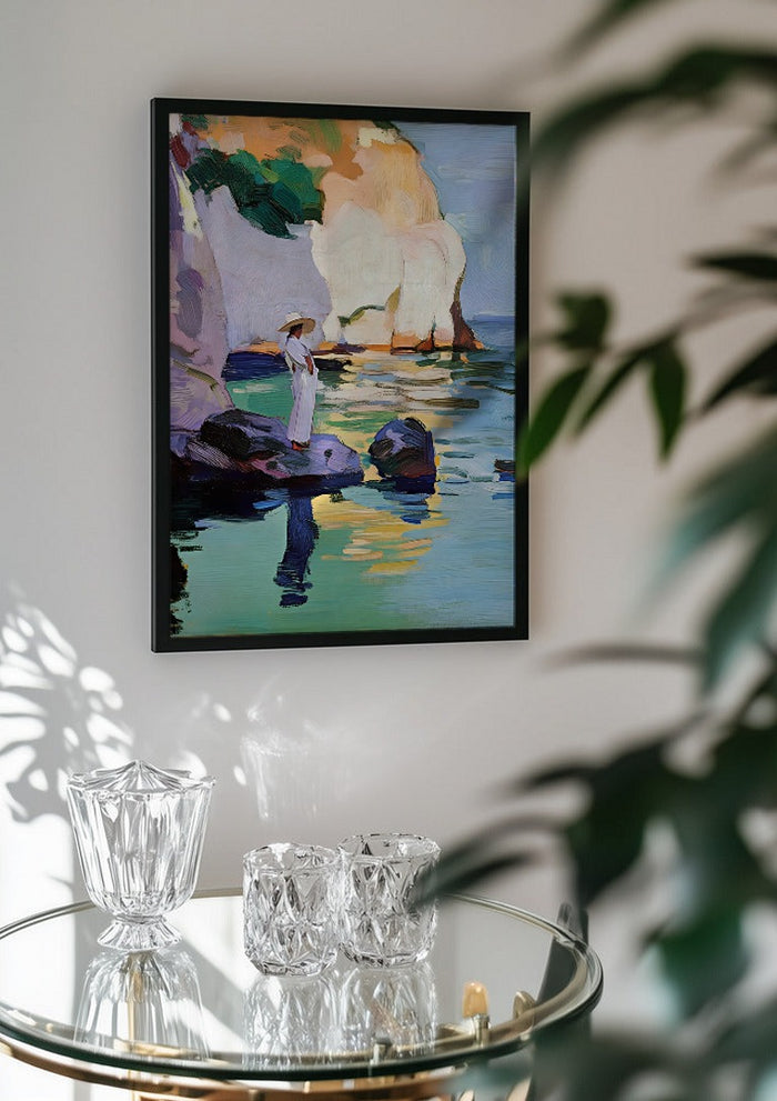 Woman by the Cliffs by Elena Avanesova in a black frame above a glass table with crystal glassware