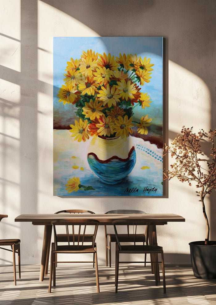 Yellow flowers by Nella Hajdu hanging above a wooden dining table in warm sunlight